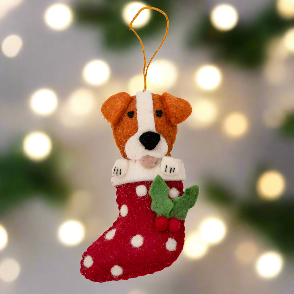 Felt dog ornament in a red stocking with white polka dots on a white background