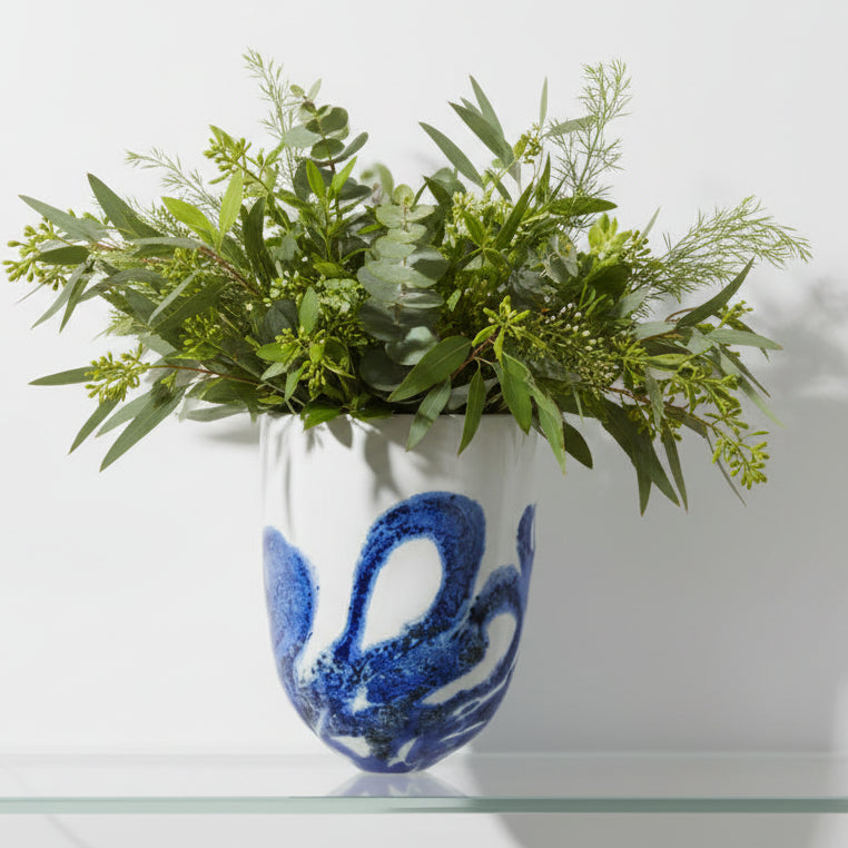 Glass vase with blue abstract design on a white background