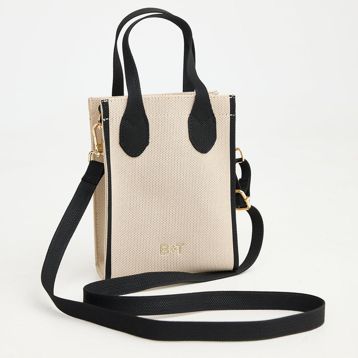Beige handbag with black accents on a white background