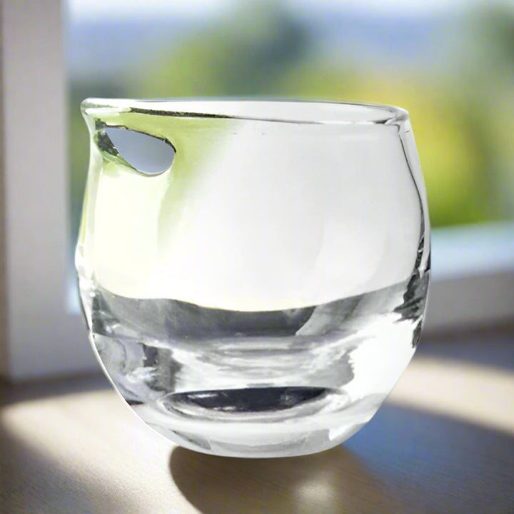 Clear glass with a green accent on a white background