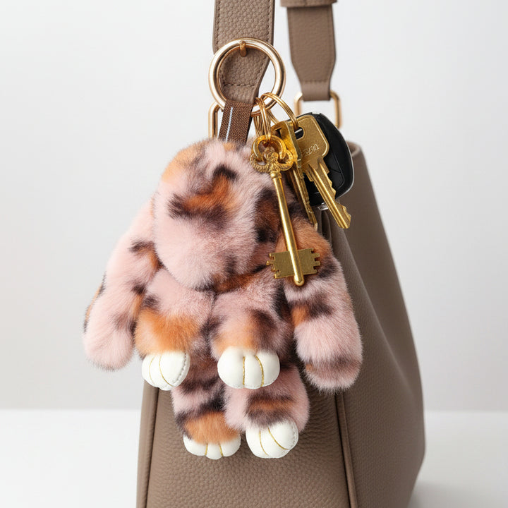 Plush tiger tail keychain on a white background