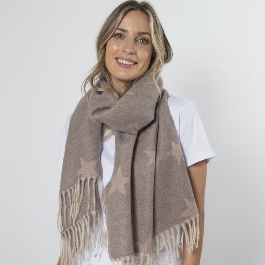 Woman wearing a brown scarf with fringe on a white background