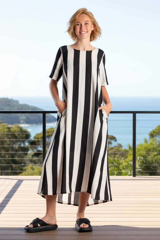 Woman wearing a black and white striped deeanne hobbs dress.