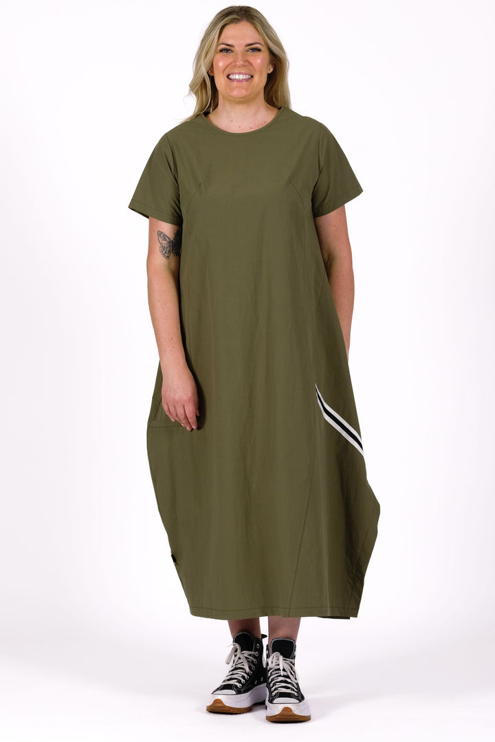 Woman wearing a green dress with white stripes on a white background