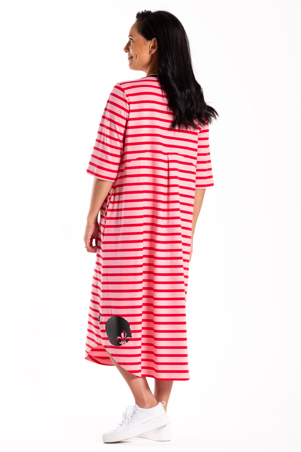 Woman wearing a red and white striped dress on a white background