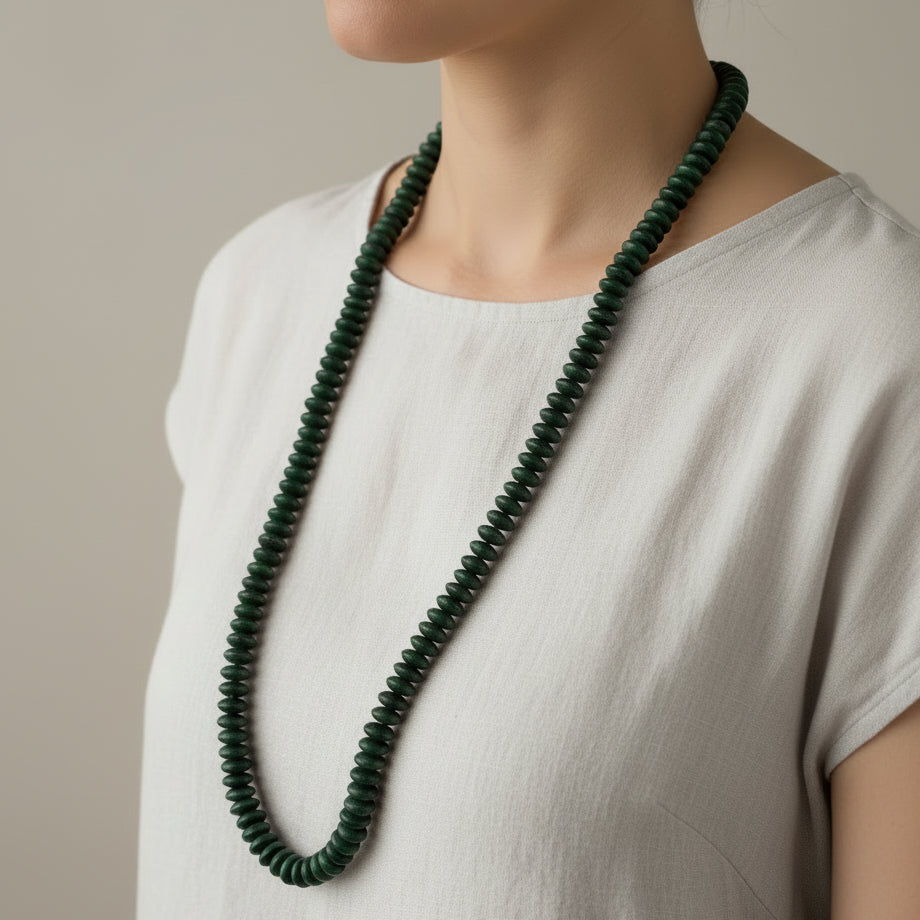 green beaded necklace on a white background