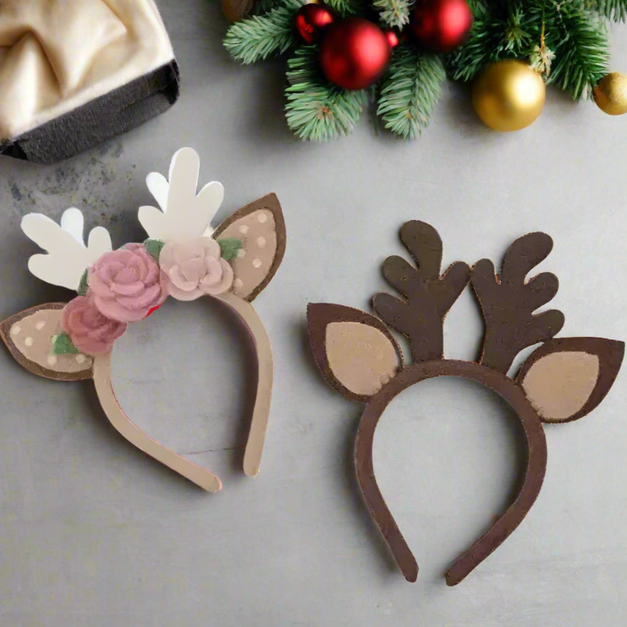 Two deer headbands with floral and antler designs on a white background