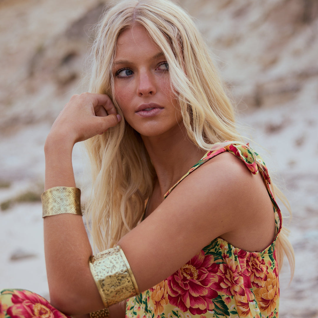 Woman in a floral dress on a beach