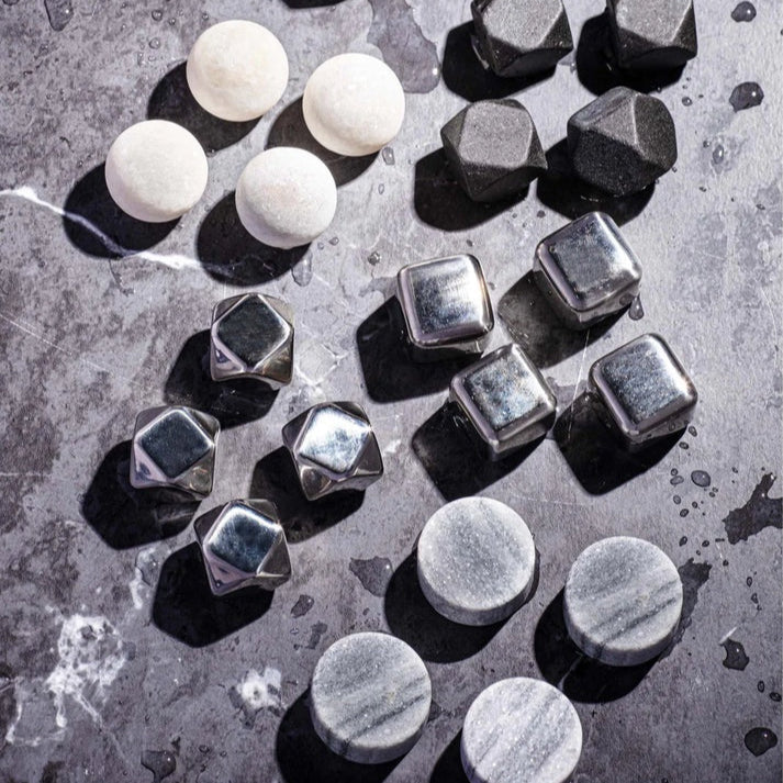 Collection of metal and marble cubes on a textured surface