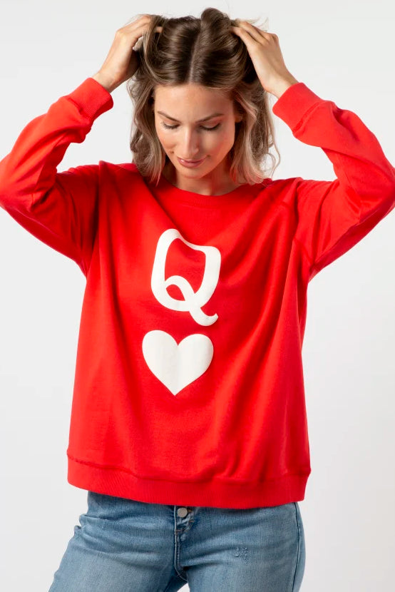 Person wearing a red sweatshirt with a white logo on a white background