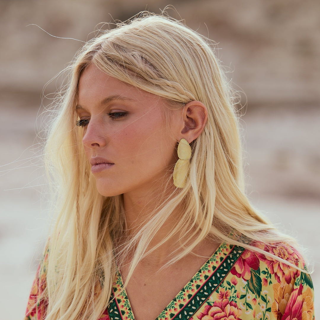Woman wearing a floral dress with a blurred natural background