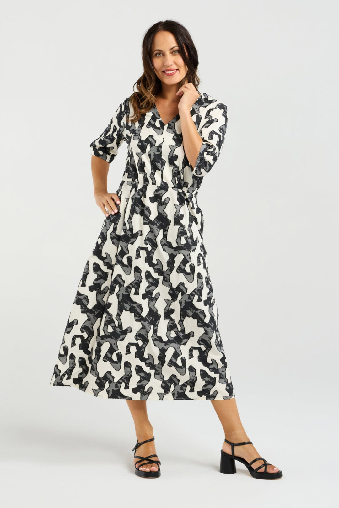 Woman wearing a patterned dress on a white background