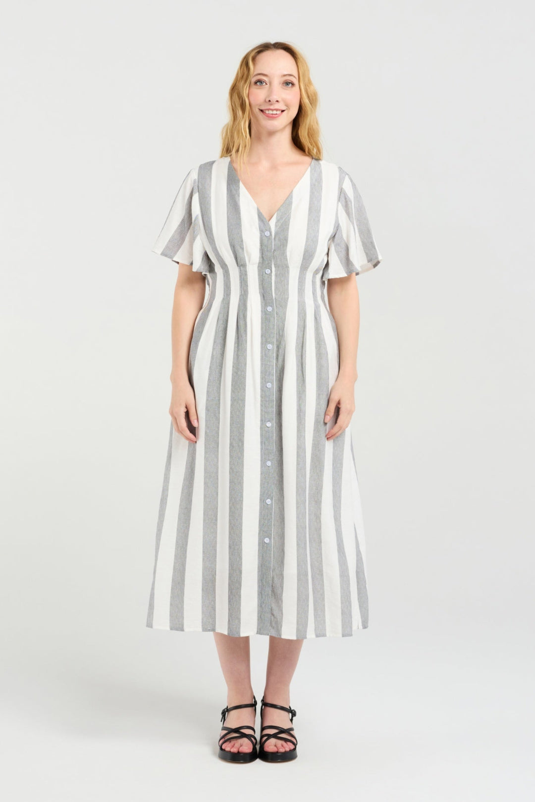 Woman wearing a striped dress on a white background