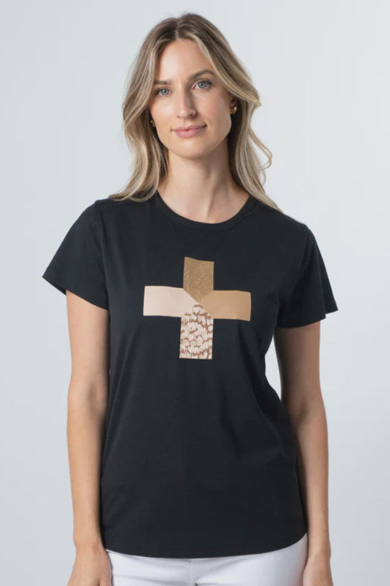 Woman wearing a black t-shirt with a gold cross design on a plain background