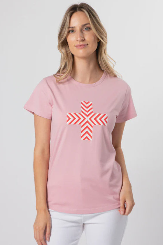 Woman wearing a pink t-shirt with a red and white geometric design on a light gray background