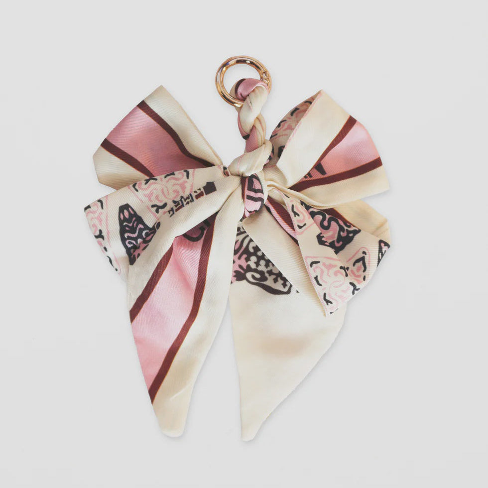 Decorative hair bow with floral pattern on a light gray background