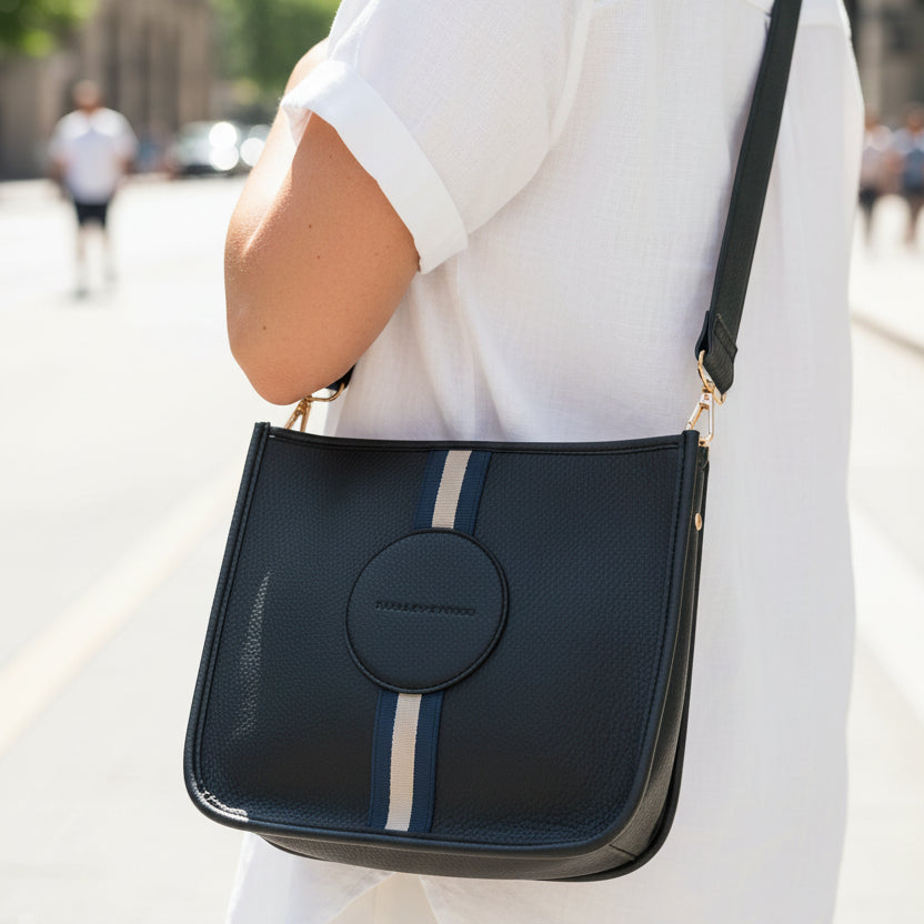 Black shoulder bag with a stripe on a white background
