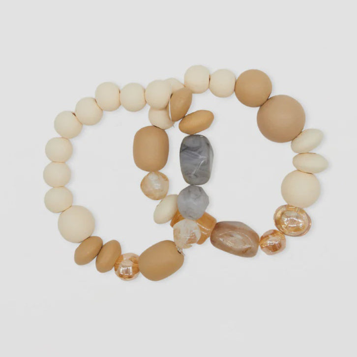 Two beaded bracelets on a light gray background