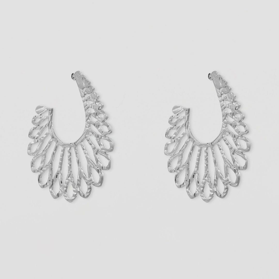 Pair of silver hoop earrings on a light gray background