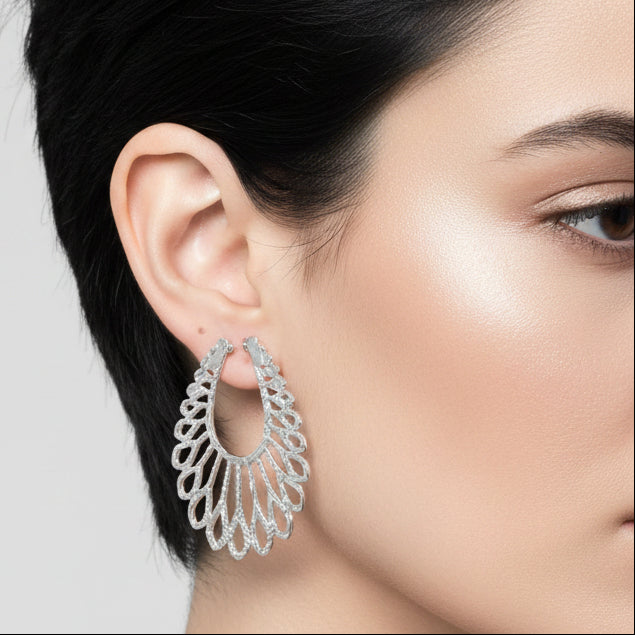 Pair of silver hoop earrings on a light gray background