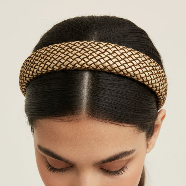 Woven headband with black center on a light gray background