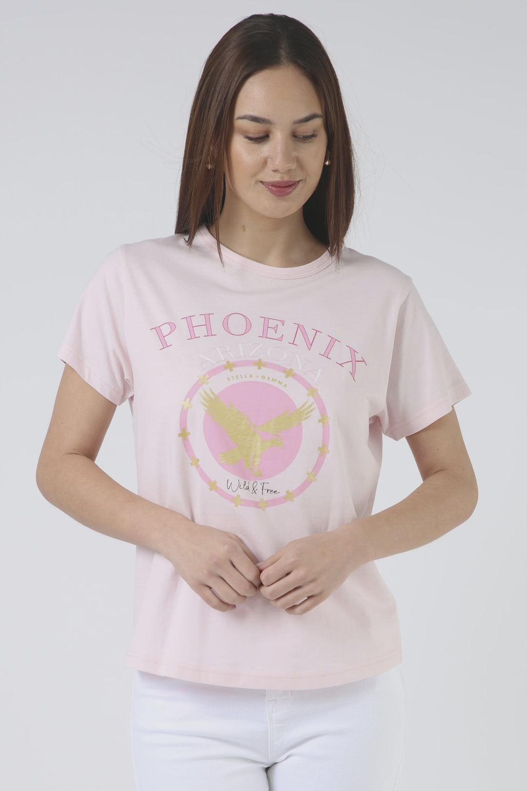 Woman wearing a pink t-shirt with 'Phoenix' design on a white background