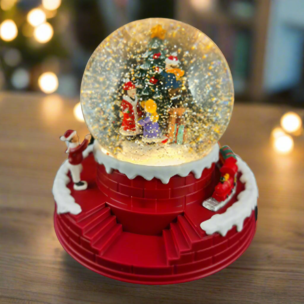 Christmas-themed snow globe with characters around a tree on a white background