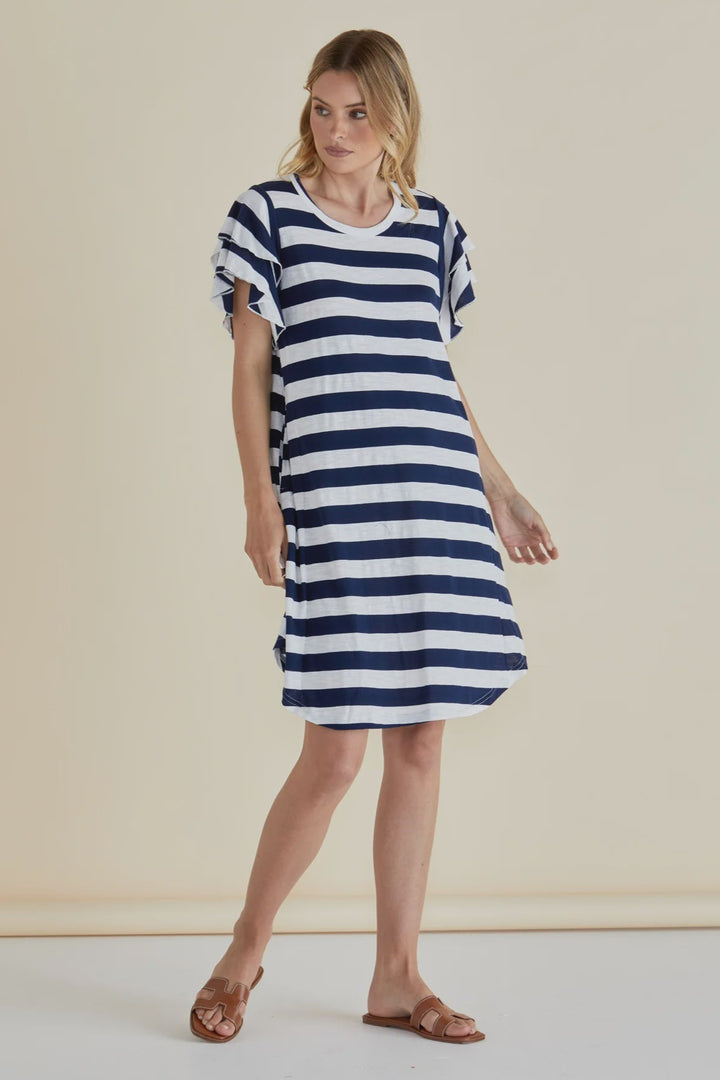Woman wearing a blue and white striped dress against a beige background