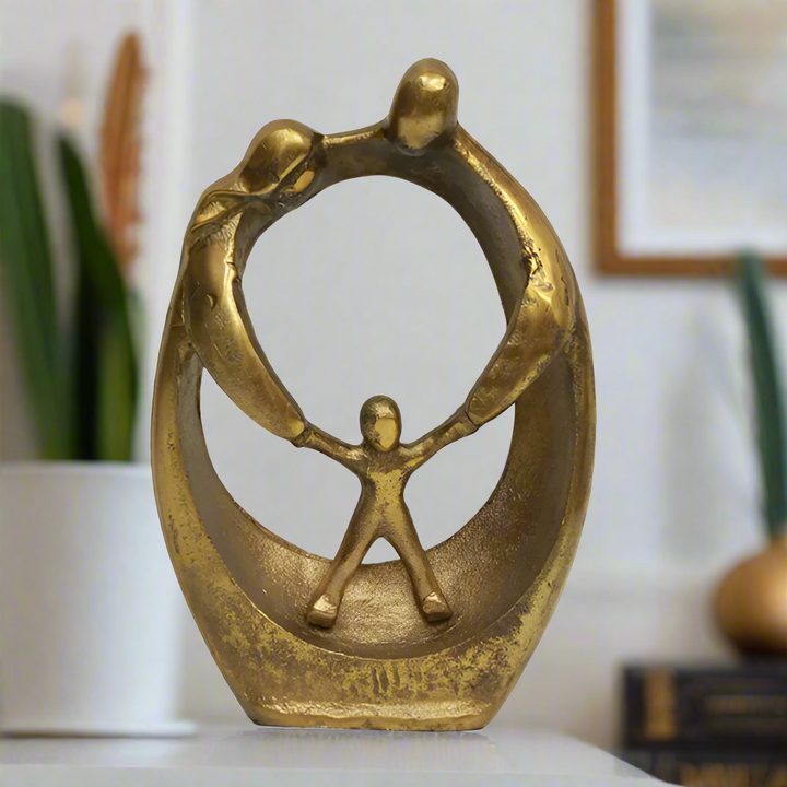 Bronze sculpture of a figure holding another figure within an oval frame on a white background