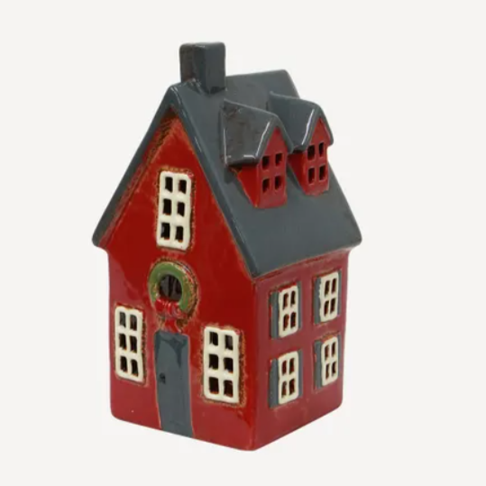 Small red house-shaped object on a white background