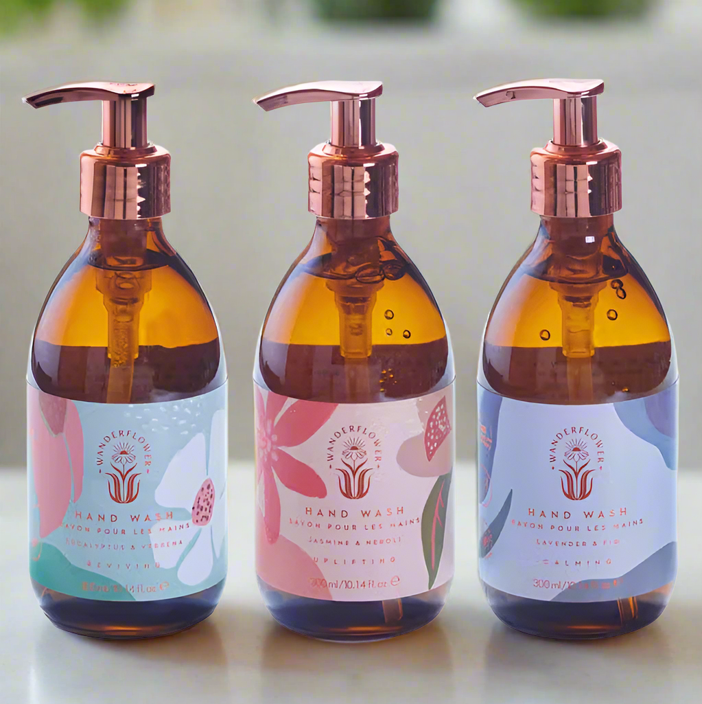 Three bottles of hand wash with pump dispensers on a white background