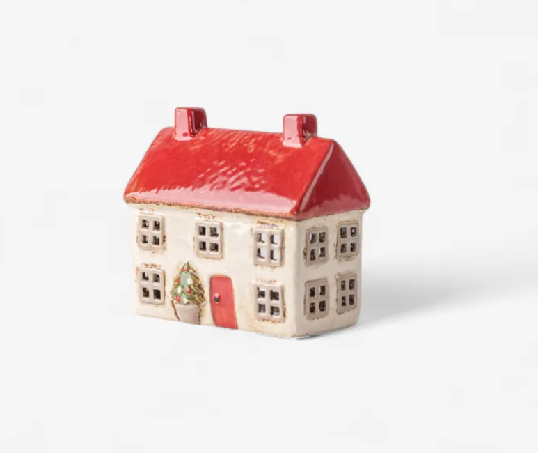 Ceramic house-shaped container with a red roof on a white background