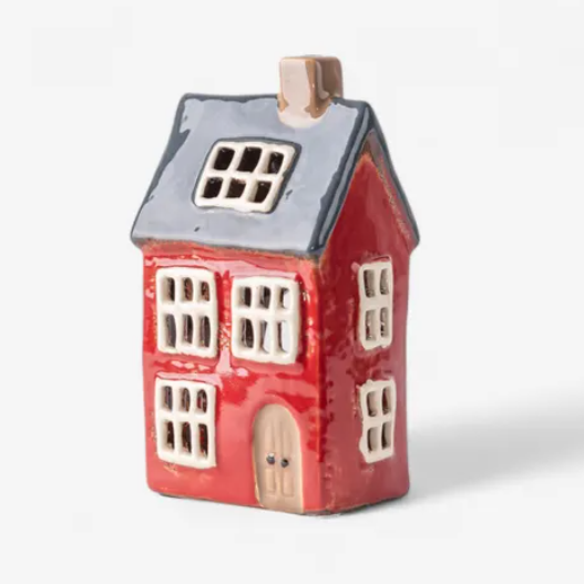 Small ceramic house-shaped object on a white background