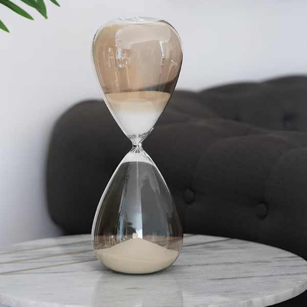 Hourglass on a marble table with a blurred background