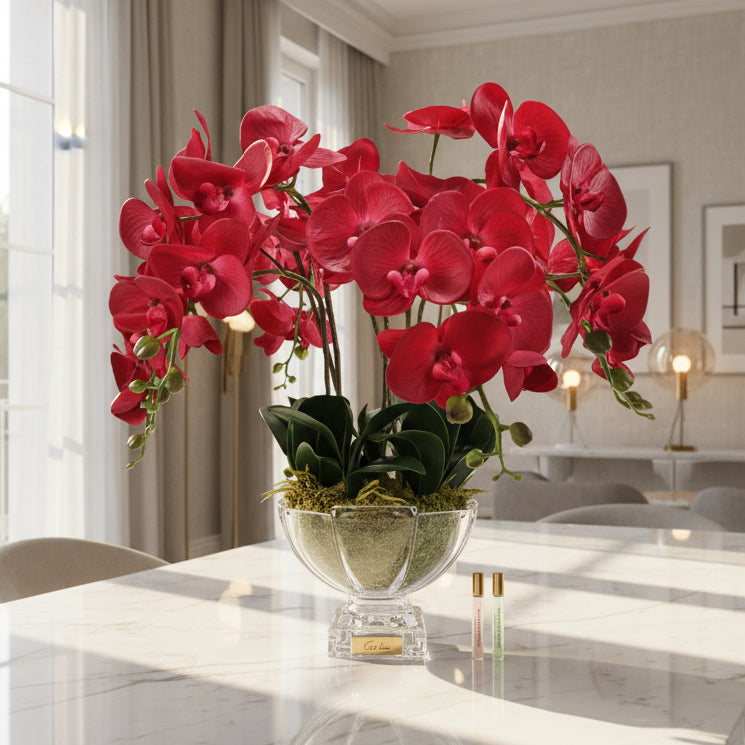 Cote Noire Red diffuser orchids in a glass vase with perfume.