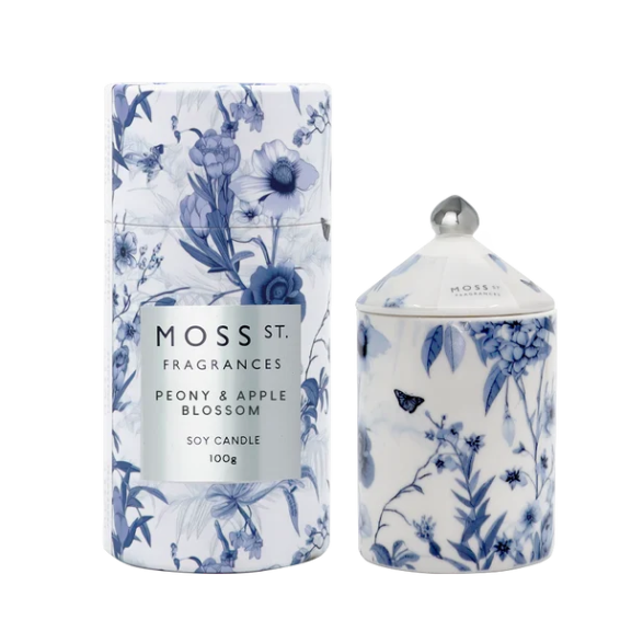 Moss St. Fragrances Peony & Apple Blossom soy candle set, featuring a cylindrical tin and a matching lidded glass jar with a blue and white floral pattern on a white background.