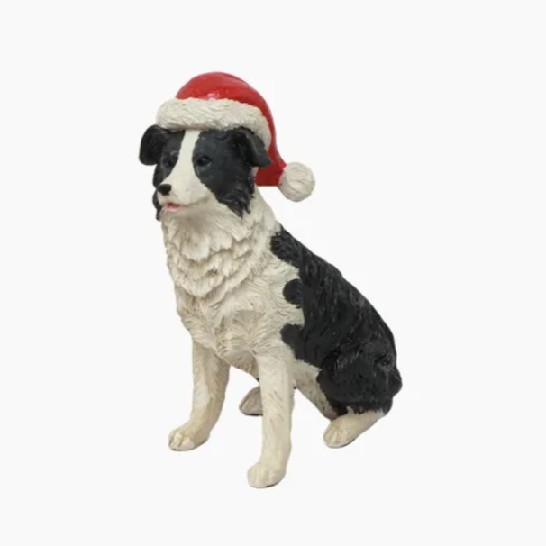 Dog figurine wearing a Santa hat on a white background