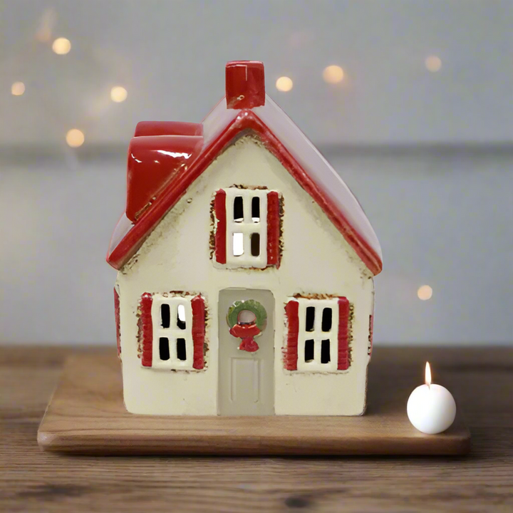 Small decorative house with a red roof on a white background
