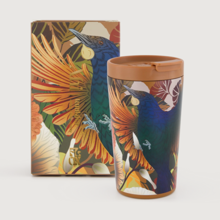 Colorful flox tumbler with bird design and matching box on a light gray background