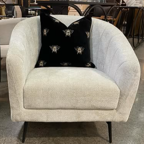Gray armchair with a black & gold bee cushion from le forge