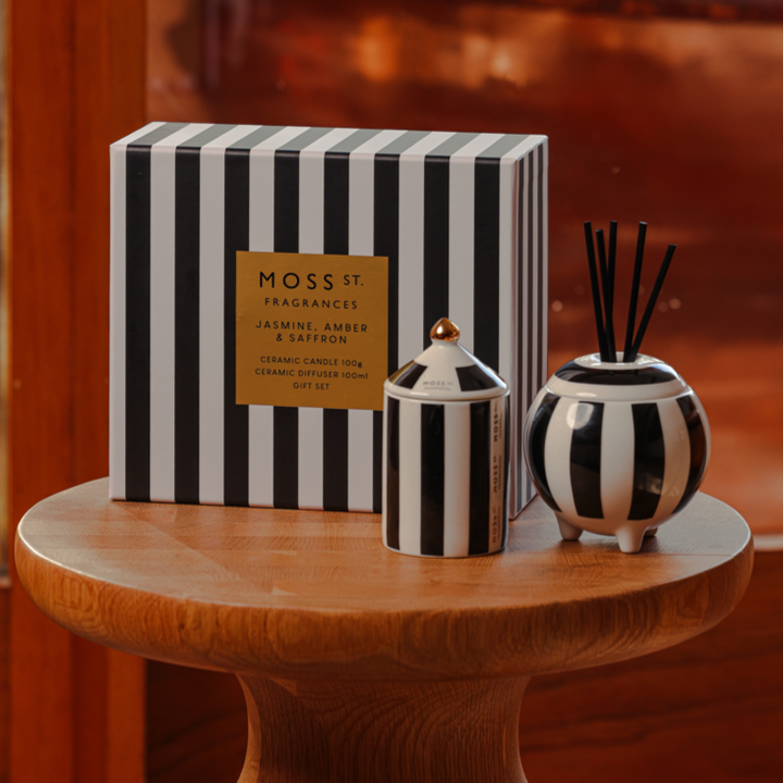 Moss & Co. striped packaging and ceramic diffuser on a wooden table