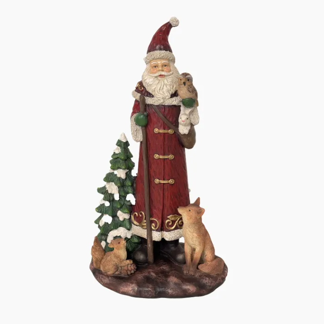 Decorative figure of a Santa Claus with a tree and two animals on a white background