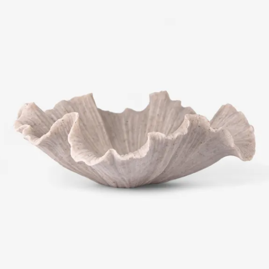 Decorative ceramic bowl with wavy edge on a white background