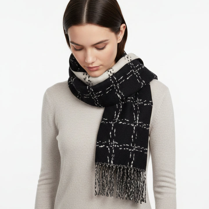 Black and white checkered scarf with fringes on a white background