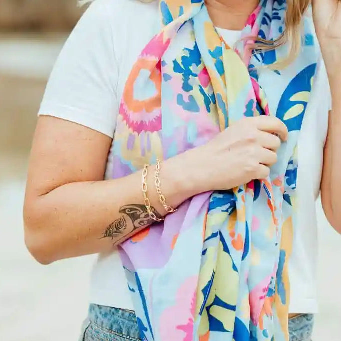 Person wearing a colorful scarf with a blurred background
