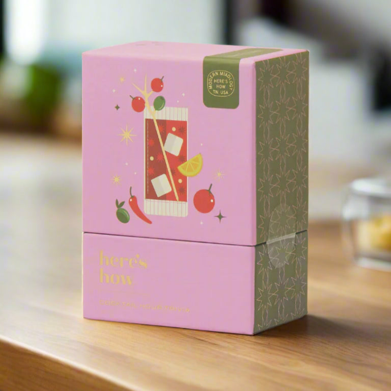 Pink and green tea box with graphics on a white background