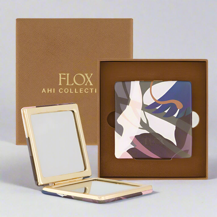 Compact mirror with floral design and 'FLOX AHI COLLECTION' packaging on a white background