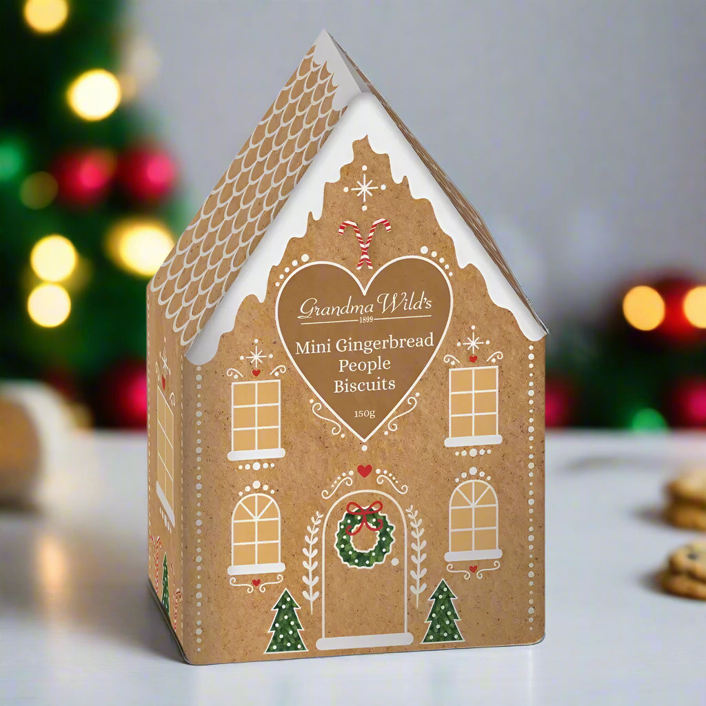 House-shaped box of Grandma Wild's Mini Gingerbread People Biscuits on a white background