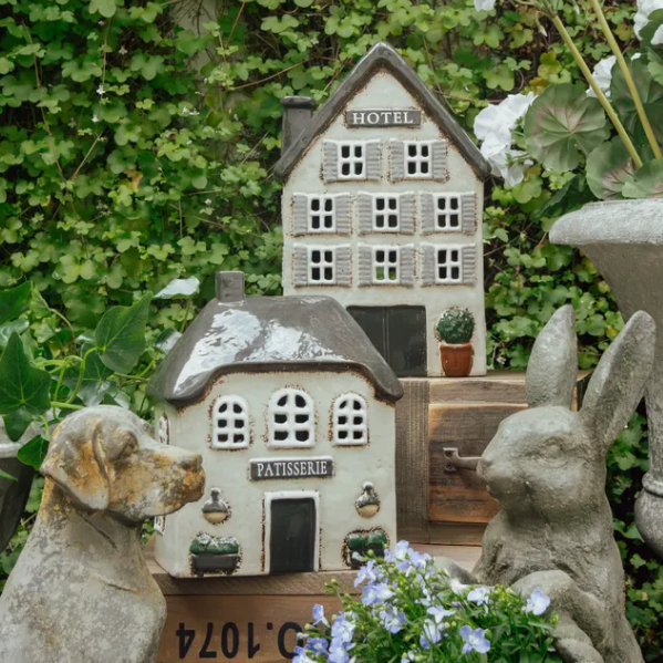Small model of a house with decorative elements in a garden setting
