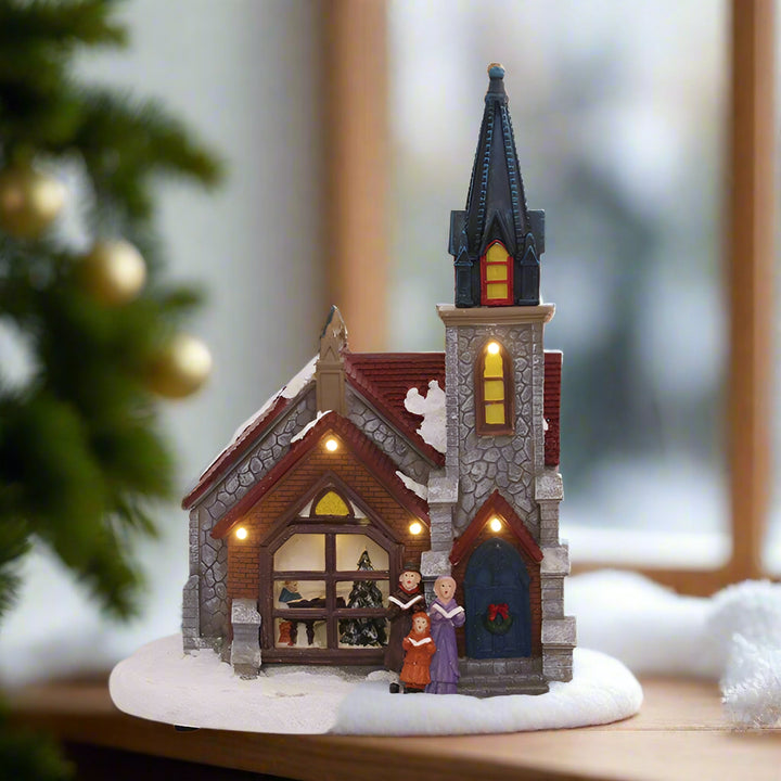 Decorative model of a church with LED lights on a white background